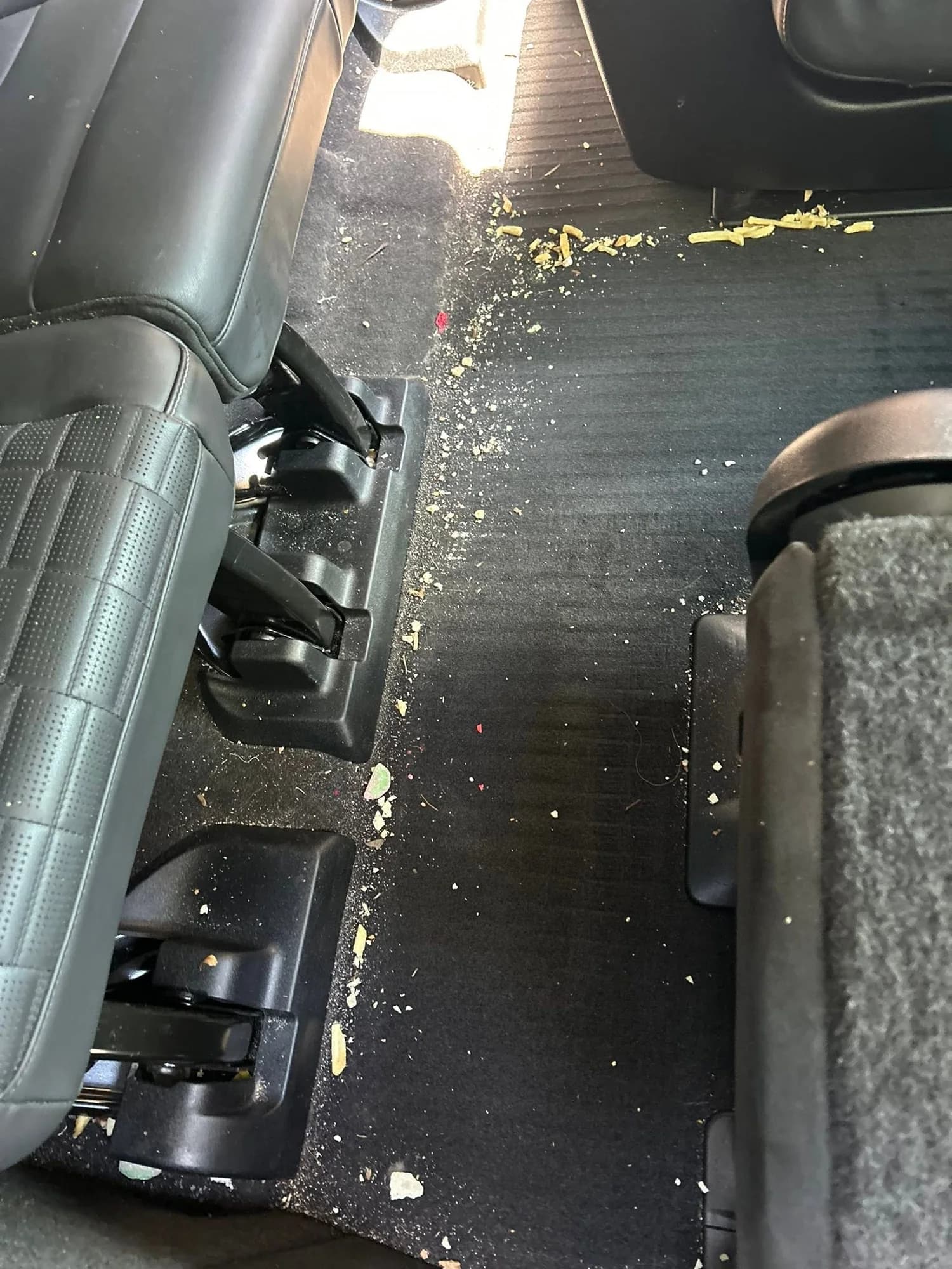 Cadillac Escalade rear floor with crumbs and debris