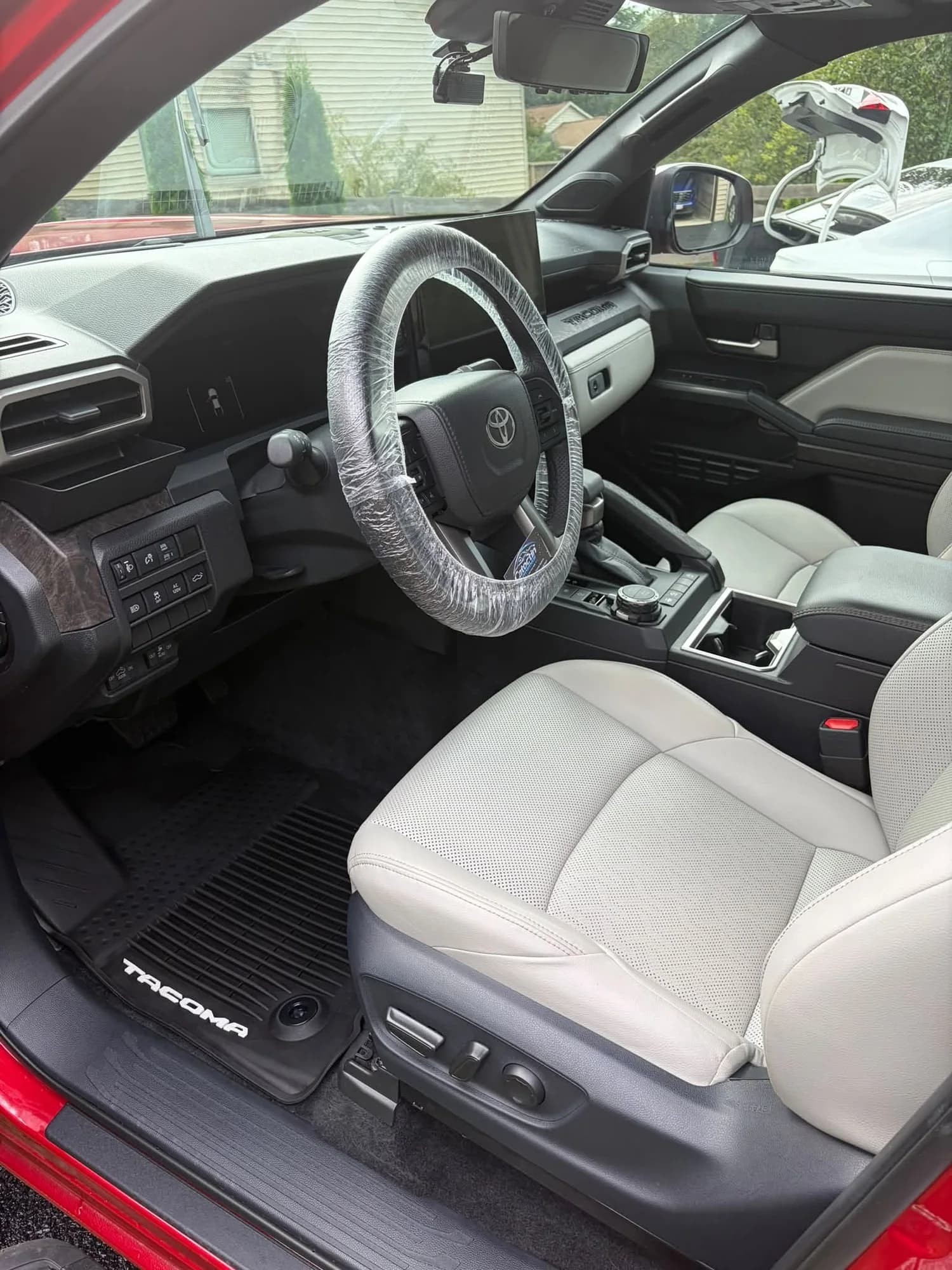 Red Toyota Tacoma front seats, steering wheel, and center console
