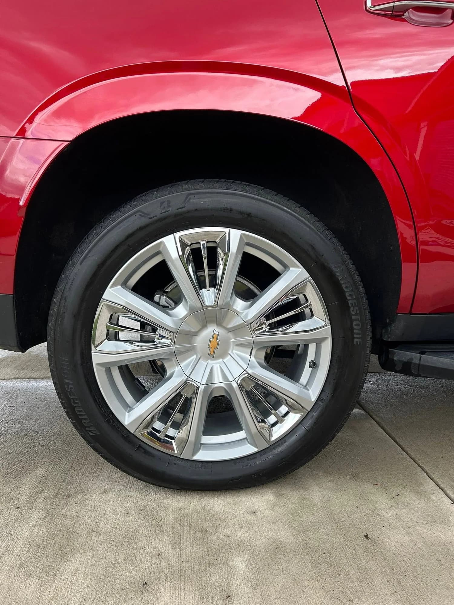 Chevrolet Tahoe wheel, tire, and red exterior panel